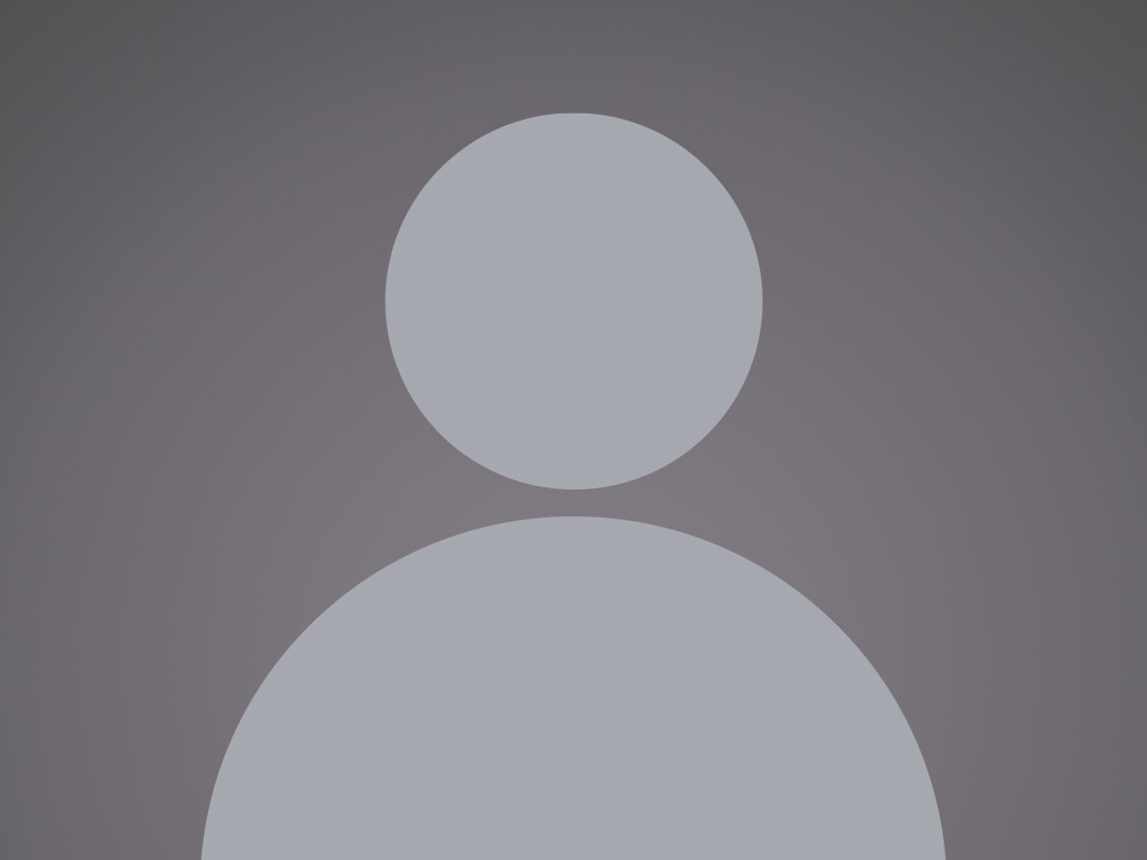 A gray silhouette of a person with a circles representing the head and body on a dark gray background.