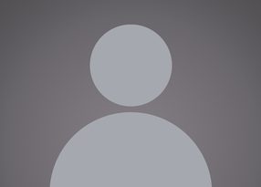 A grey silhouette of a person with a circular head and rounded shoulders against a dark background.