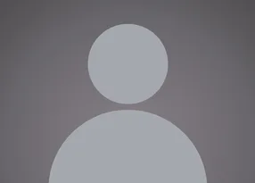 A grey silhouette of a person with a circular head and rounded shoulders against a dark background.