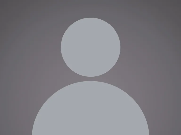 A grey silhouette of a person with a circular head and rounded shoulders against a dark background.