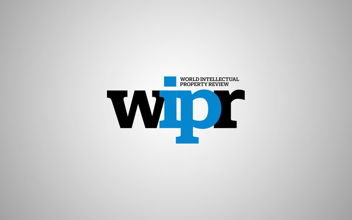 Logo of World Intellectual Property Review with the letters wipr in black and blue on a grey gradient background.