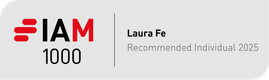 A digital badge with the text "I AM 1000" in large letters, alongside the name "Laura Fe" and the description "Recommended Individual 2025" on a grey background.