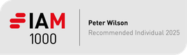A designed badge with "I AM 1000", the name Peter Wilson, and "Recommended Individual 2025" on a light grey background.