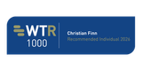 Blue badge showing left white letters WTR with a gold R and 1000; to the right, Christian Finn in white and Recommended Individual 2026 in gold, divided by a vertical line.