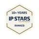 Beige octagonal badge with a gold outline and navy text reading “10+ YEARS IP STARS from ManagingIP RANKED,” featuring a star in the STARS logo.