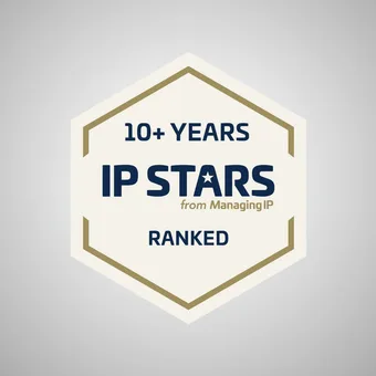 Hexagon badge with text celebrating over 10 years of IP Stars from Managing IP, ranked, on a light grey background.