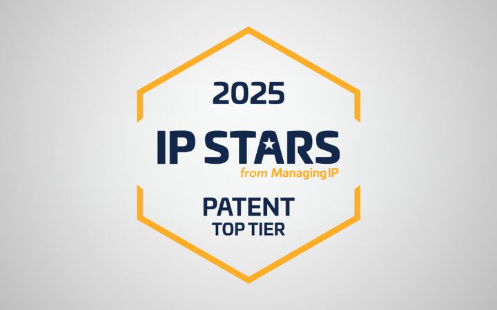 Hexagon badge with "2025 IP STARS from ManagingIP" text and "Patent Top Tier" on a grey background.
