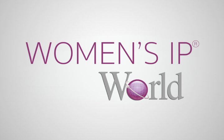 Logo reading WOMEN'S IP World, with WOMEN'S IP in purple and World in grey, the O in World replaced by a purple globe, on a light gradient background.