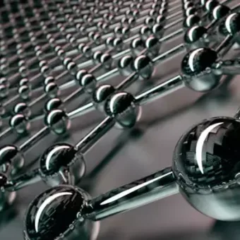 Close-up of a metallic molecular or atomic structure with interconnected spheres and rods, exhibiting a shiny reflective surface.