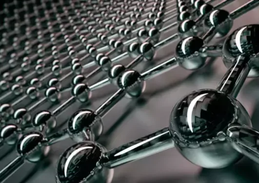 Close-up of a metallic molecular or atomic structure with interconnected spheres and rods, exhibiting a shiny reflective surface.