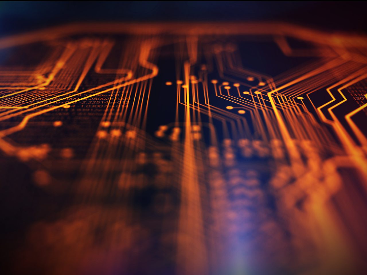 Close-up of glowing orange circuit lines and data on a dark electronic circuit board.