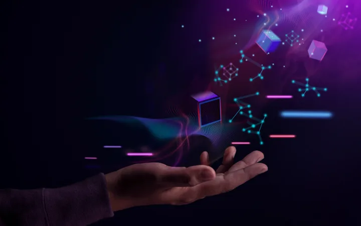 A hand reaches out towards glowing digital quantum structures, including cubes, lines, and network-like shapes, set against a dark background with vibrant purple and blue highlights.