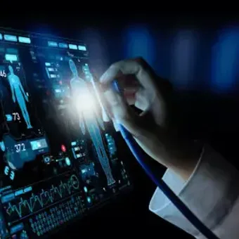 A hand interacts with a digital touchscreen displaying medical data and vital signs in a high-tech environment.