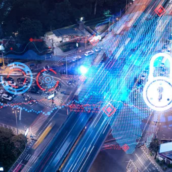A city street at night overlaid with digital security icons, graphs, and data streams highlighting cybersecurity and digital protection themes.
