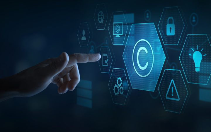 A hand interacts with a digital interface featuring icons for copyright, security, ideas, and settings, against a dark background.