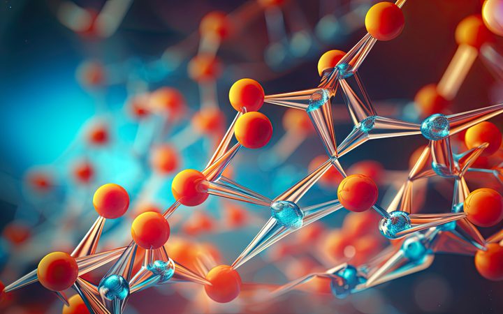 A digital illustration of a molecular structure with interconnected orange and blue spheres and metallic bonds against a blurred, colorful background.