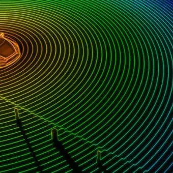 A car in the top left corner surrounded by colourful radar waves and signal lines, illustrating autonomous vehicle sensors and environmental awareness.