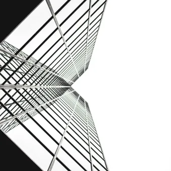 Looking up at a modern skyscraper with reflective glass windows, structural lines, and a stark contrast between the dark and white sections.