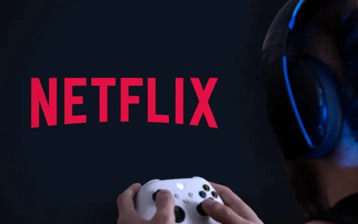 Person wearing headphones and holding a game controller, facing a screen with the Netflix logo on a dark background.