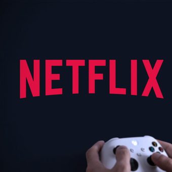 Person playing video games with a controller while wearing a gaming headset, looking at a screen displaying the Netflix logo.