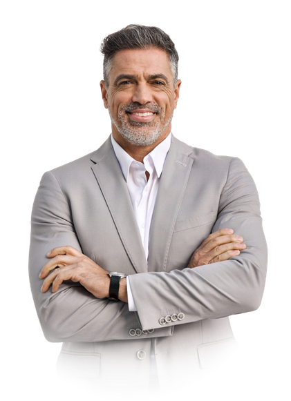 Smiling person with short grey hair and beard, wearing a light grey suit and white shirt, arms crossed.