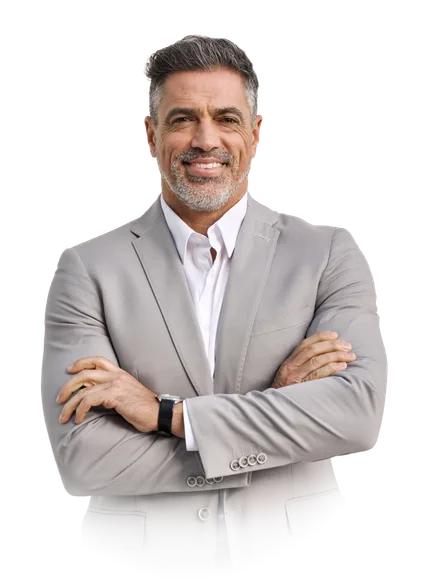 Smiling person with short grey hair and beard, wearing a light grey suit and white shirt, arms crossed.